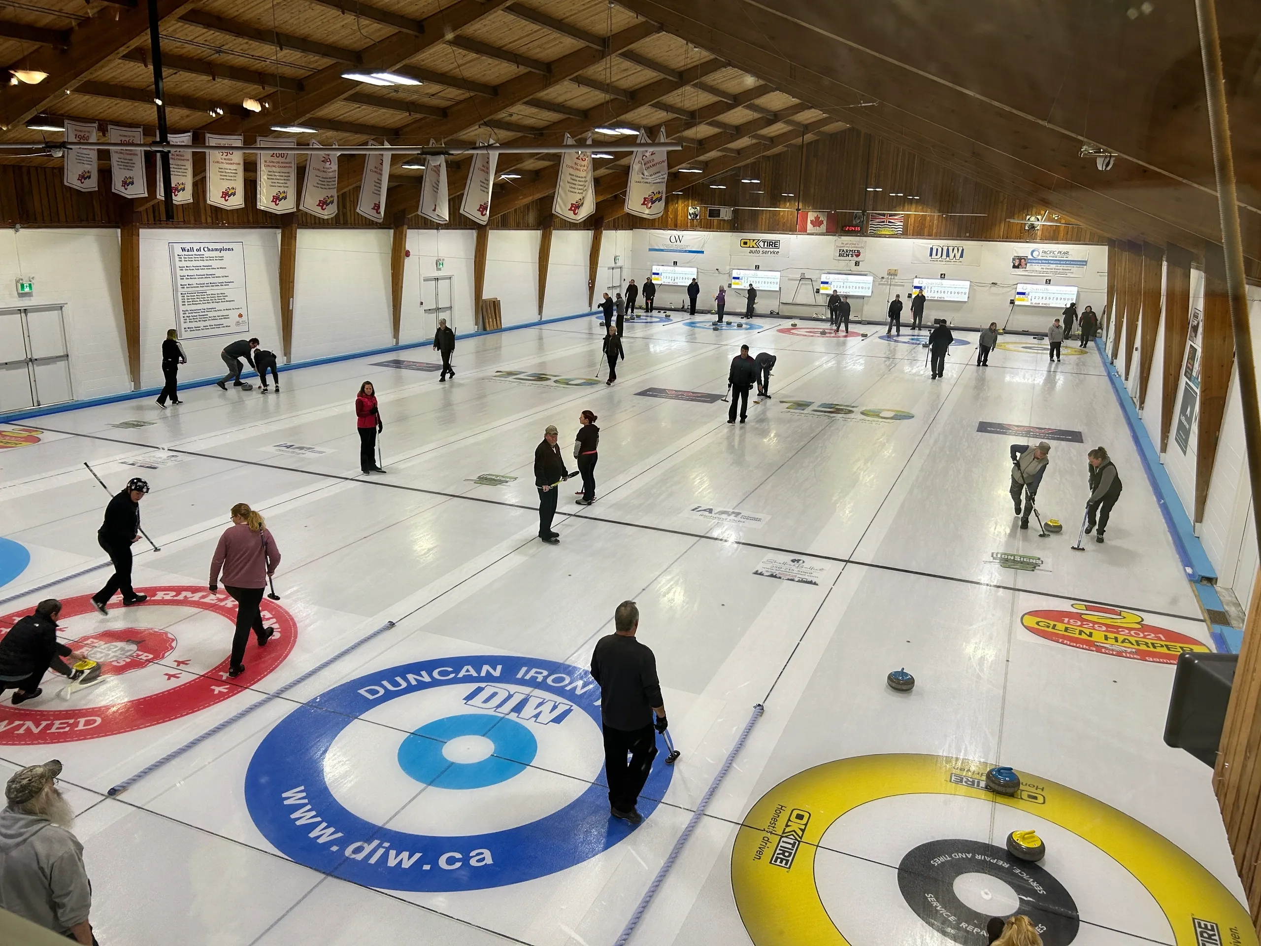 A curling club with people using curling equipment.